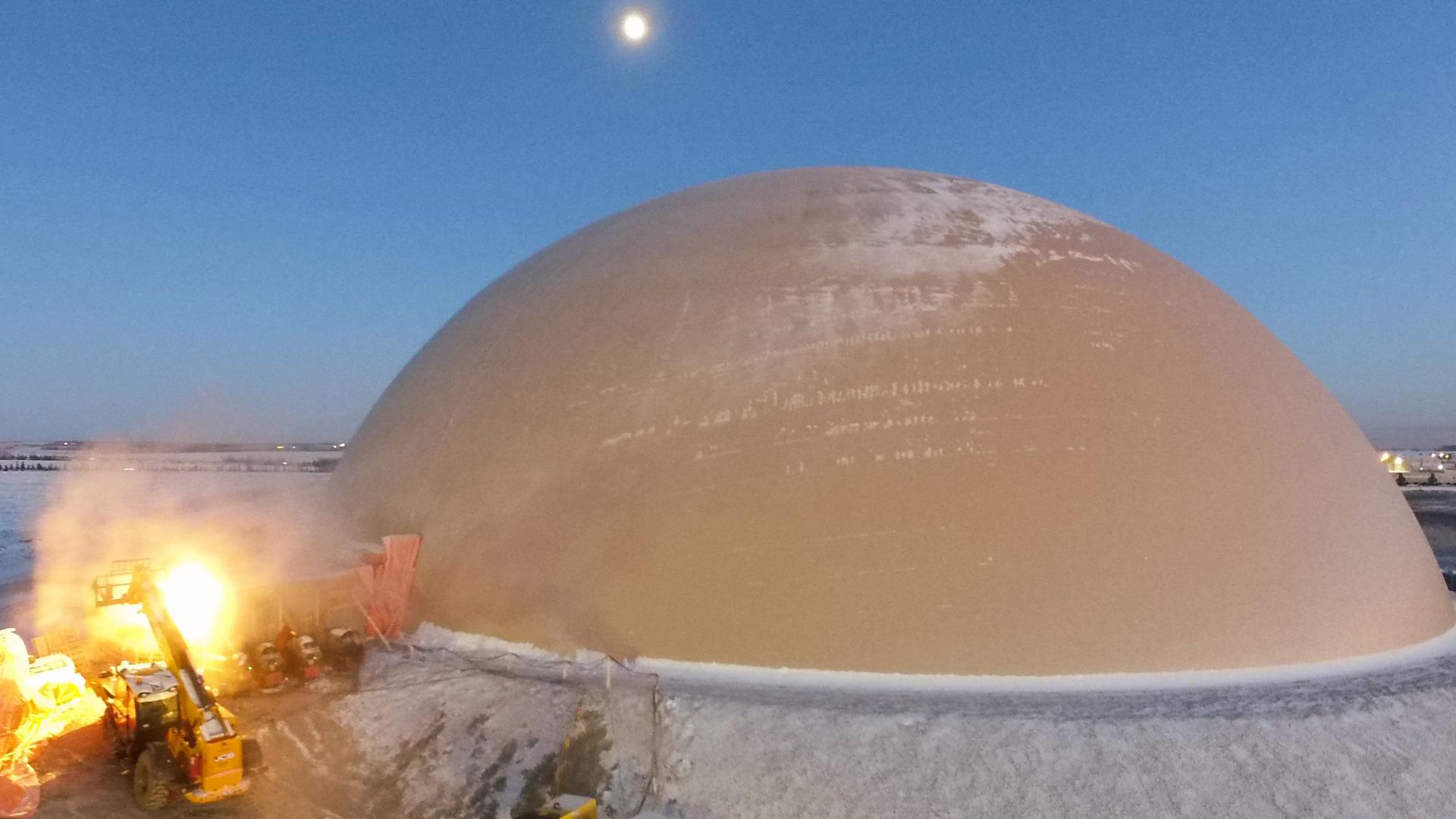 Drone view of snow covered, 182-foot diameter dome in Alberta, Canada.