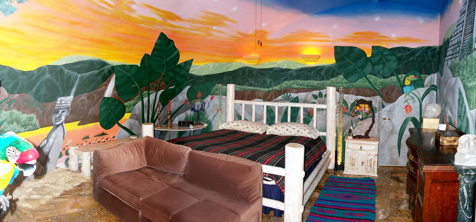 Mayan-themed bedroom features a Peruvian sunset mural. 