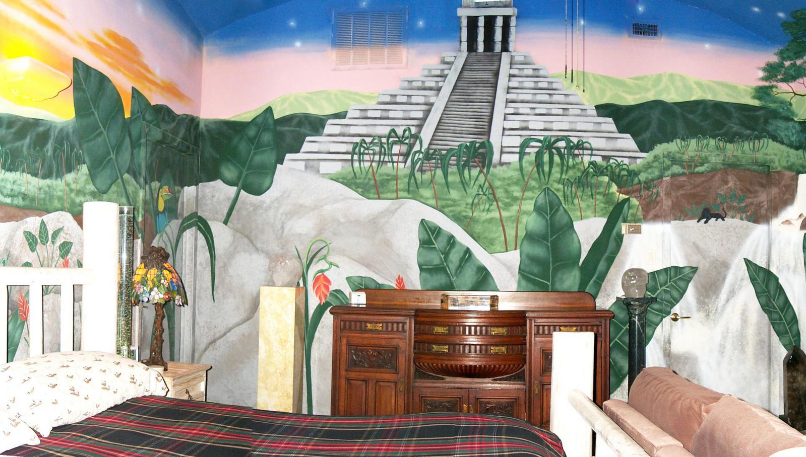 The "mayan" bedroom features a mural of a Mayan pyramid. 