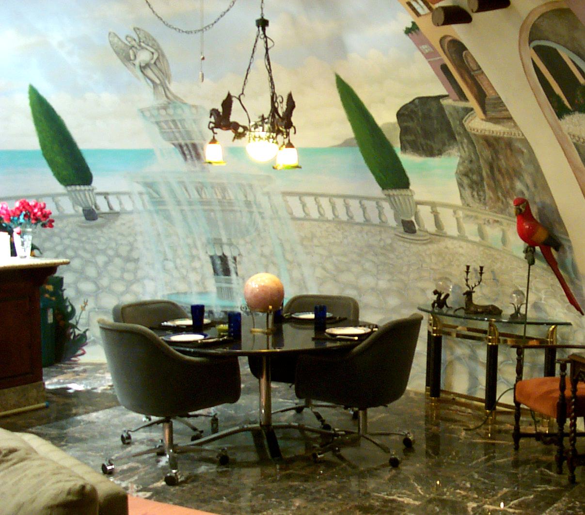 Murals in the dining room echo an outdoor, seaside cafe. 