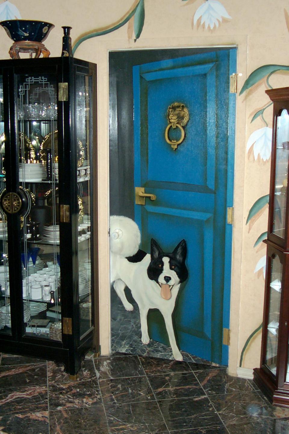 The pantry door is painted in a mural featuring Glenn Young's dog, Akita. 