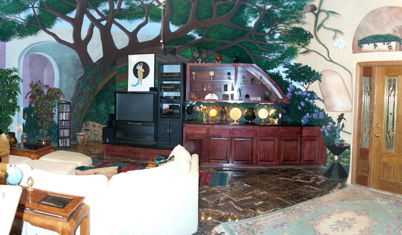 The main living area of the great room features an indoor forest mural.