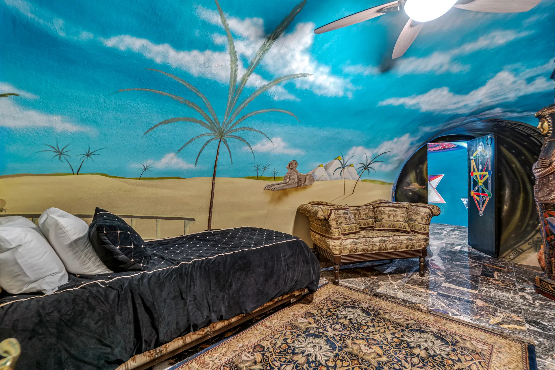 A daybed and settee are shown in the third bedroom along with a doorway leading to a dedicated meditation space.