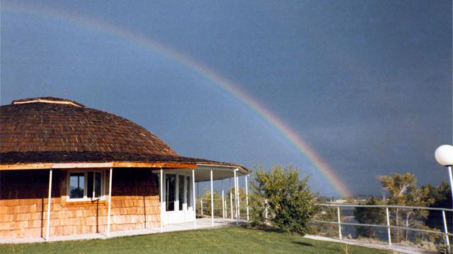 A rainbow echos the curvature of the Monolithic Dome home.