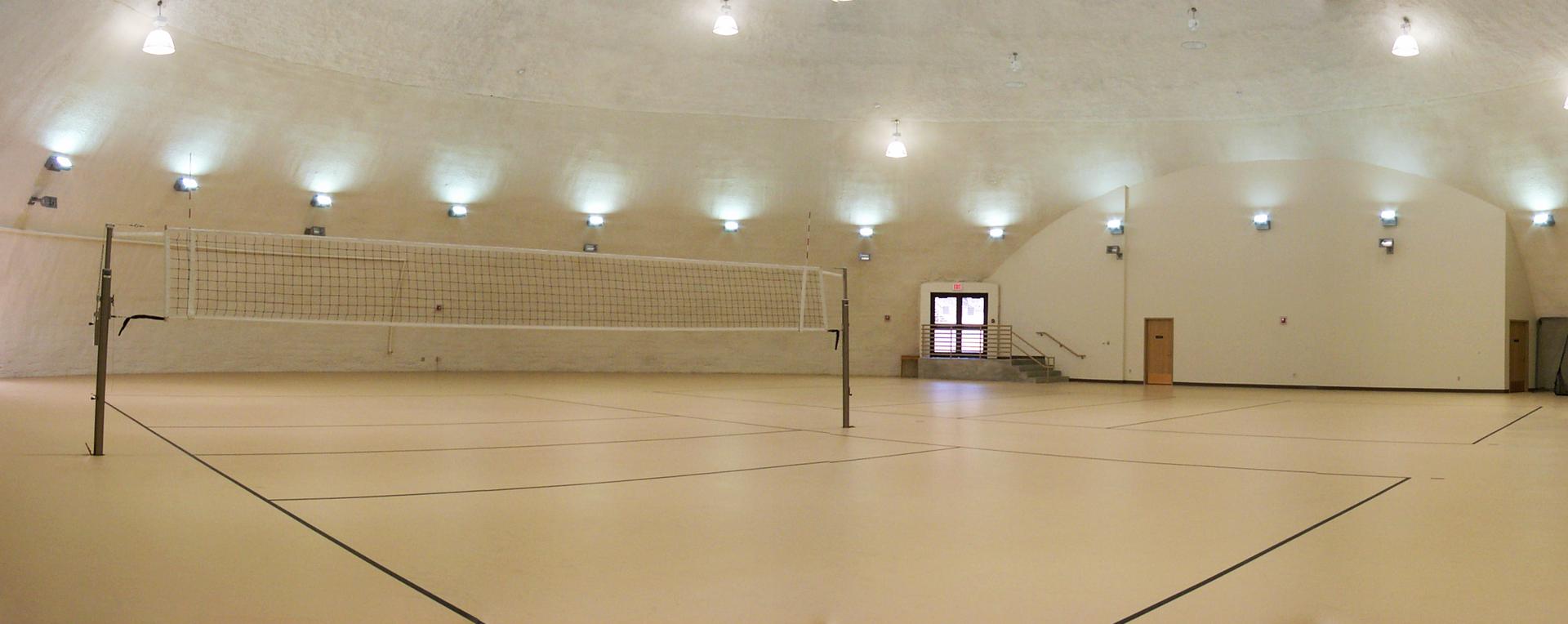 A volleyball net set up inside the practice gymnasium.