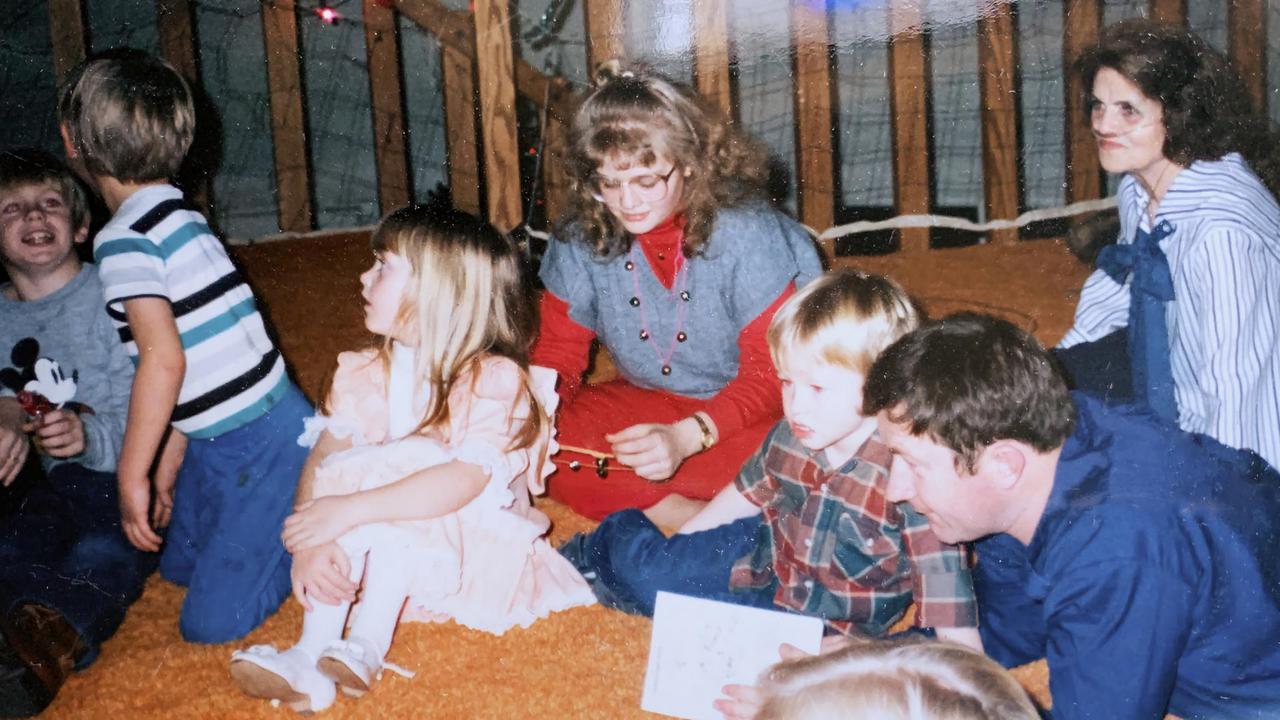 Melinda South (center, in red), Marjorie South (right, seated) with siblings, cousins and relatives at a party in the loft.