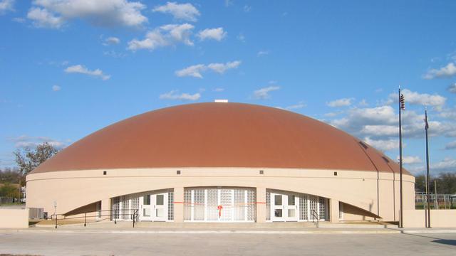An orange ribbon across the front of the new Avalon Multipurpose Center.