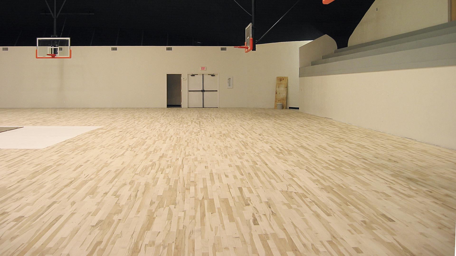 The wood basketball court floor is install, but still needs to be stained and sealed.