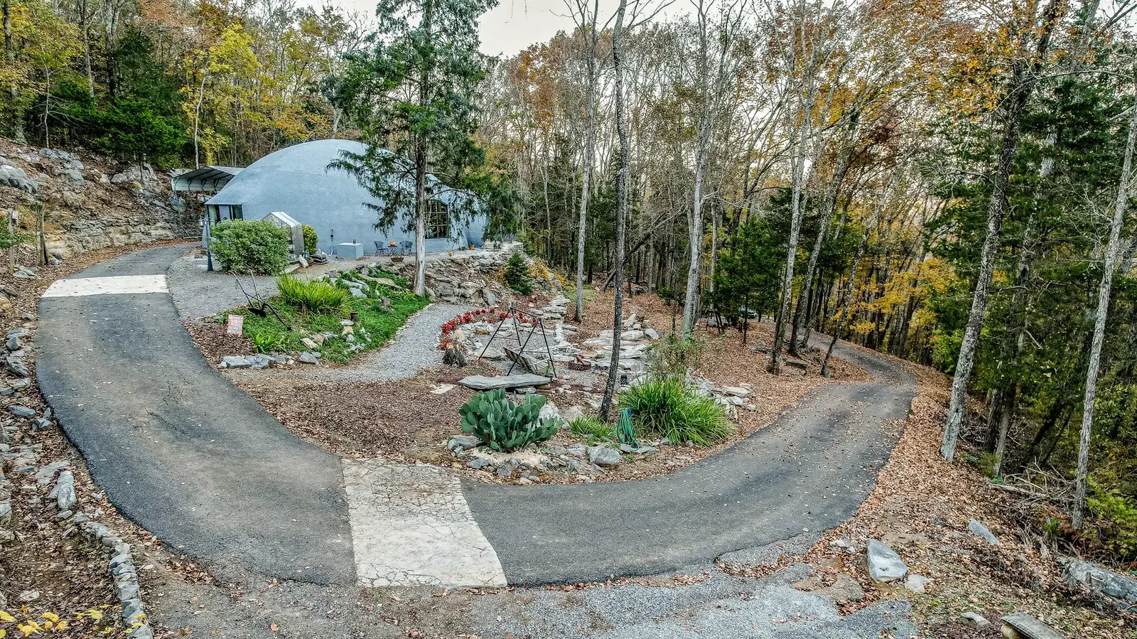 There is a long, winding driveway to the home.