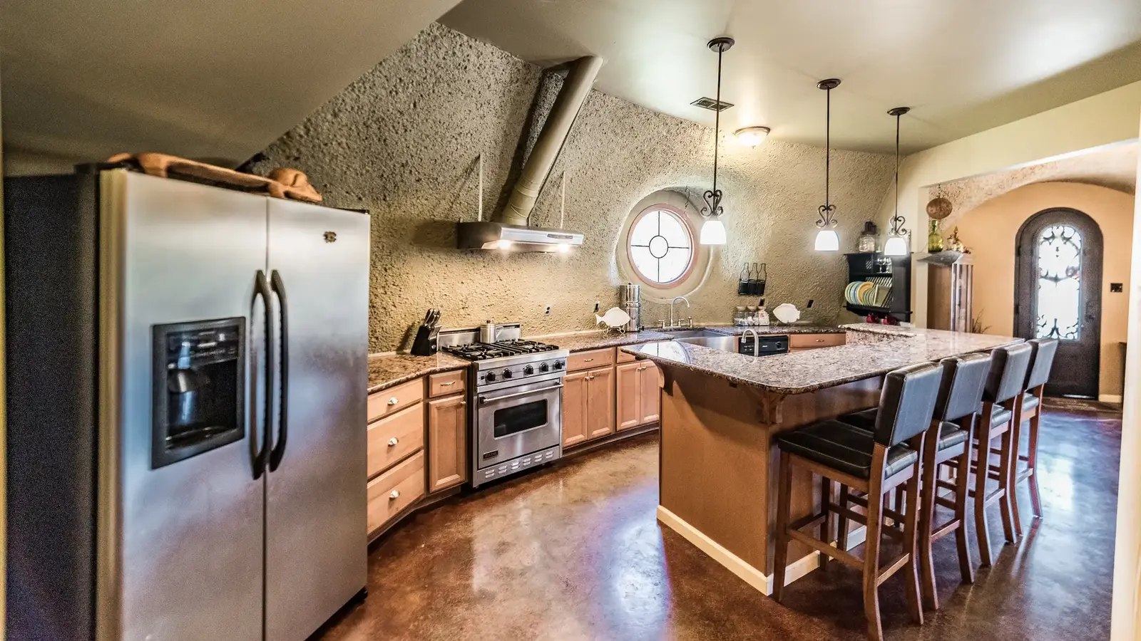 The large kitchen with island and bar.