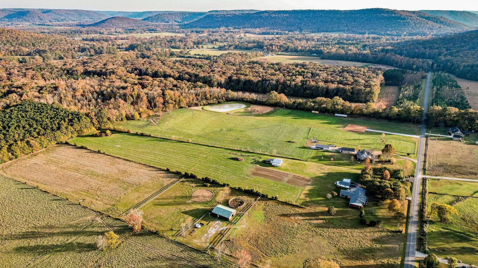 An aerial view of the rural valley below the home.