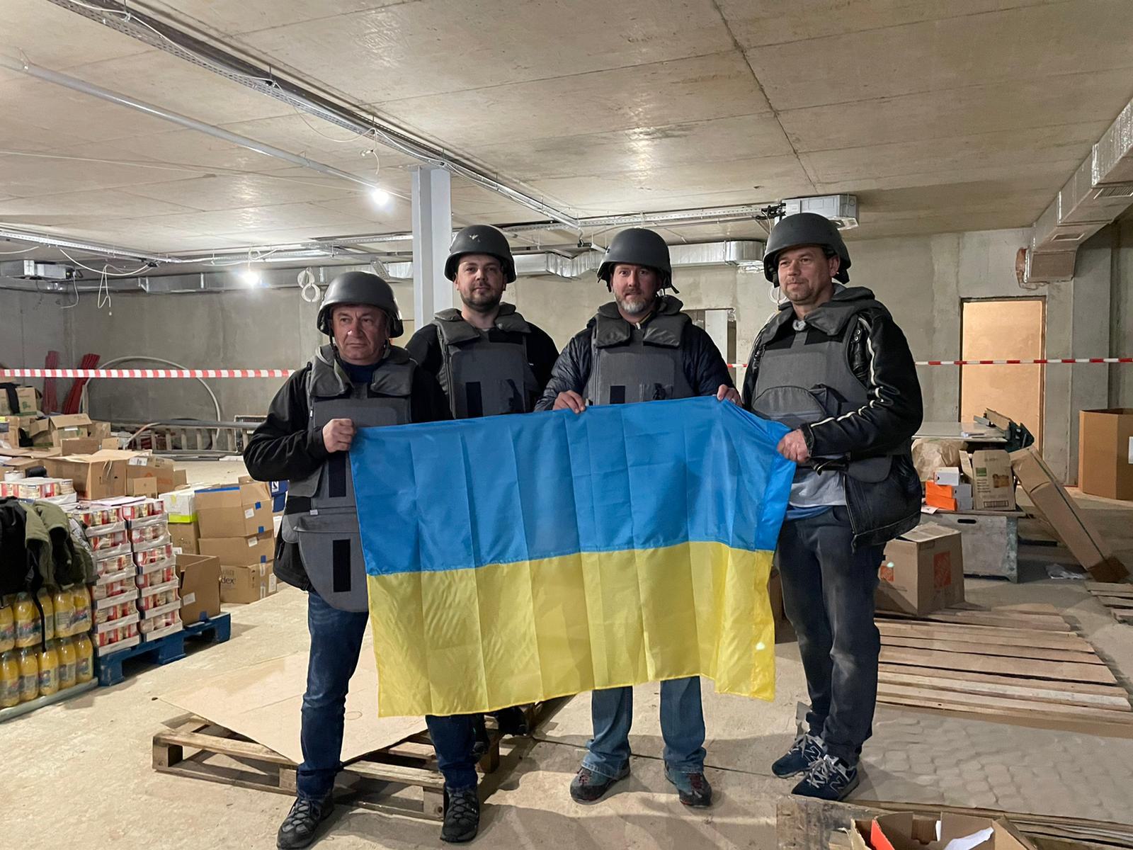 Volunteers wear body armor to deliver supplies inside Ukraine.