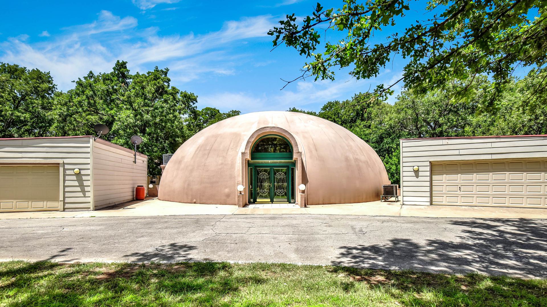Exterior view of dome home and garages.