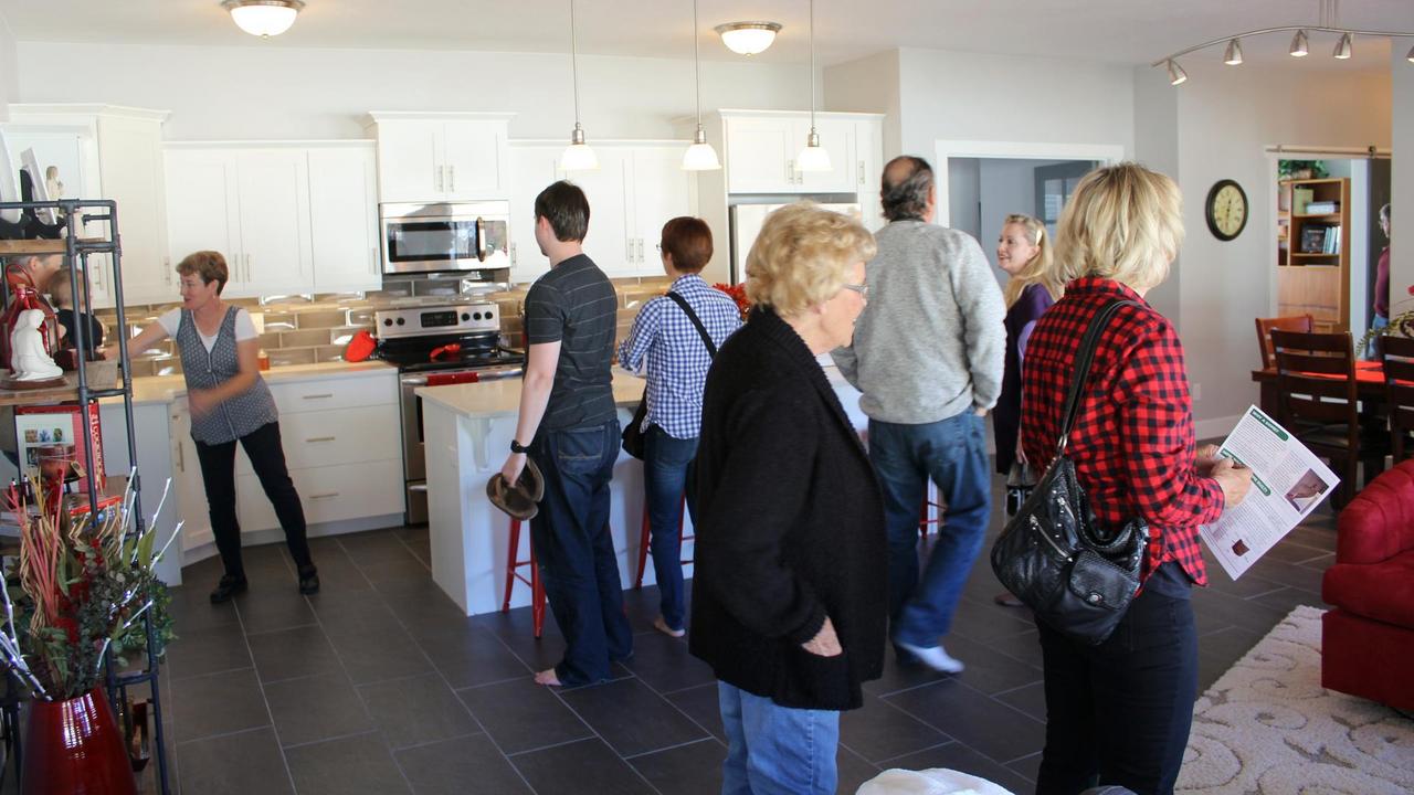 Visitors Tour the Great Room and Kitchen.