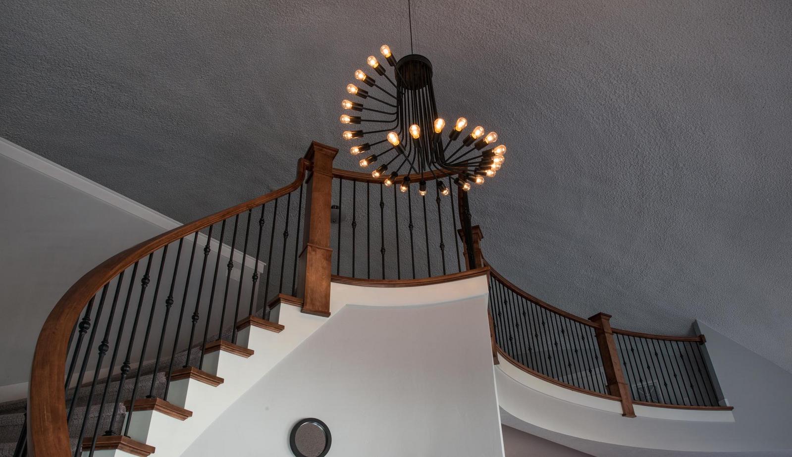 Curved chandelier and staircase.