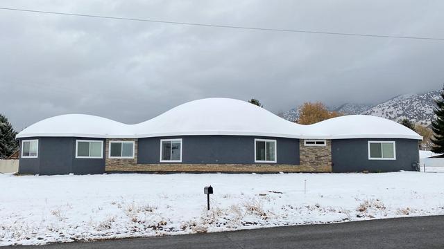 Snow covers the Monolithic Dome home.