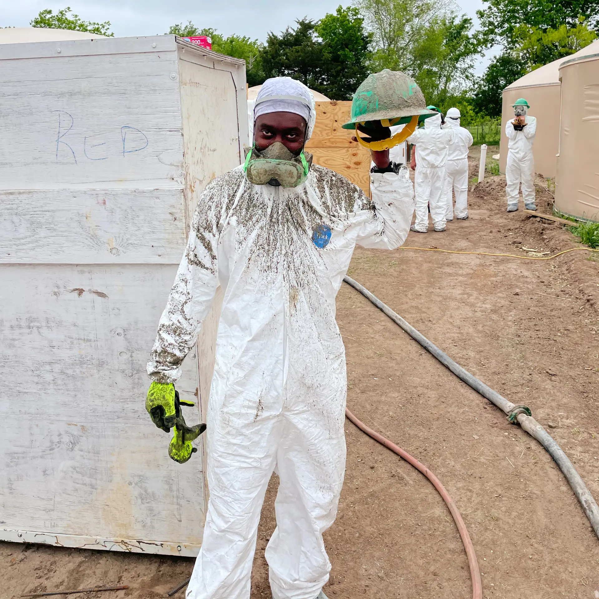 Student covered with shotcrete overspray.