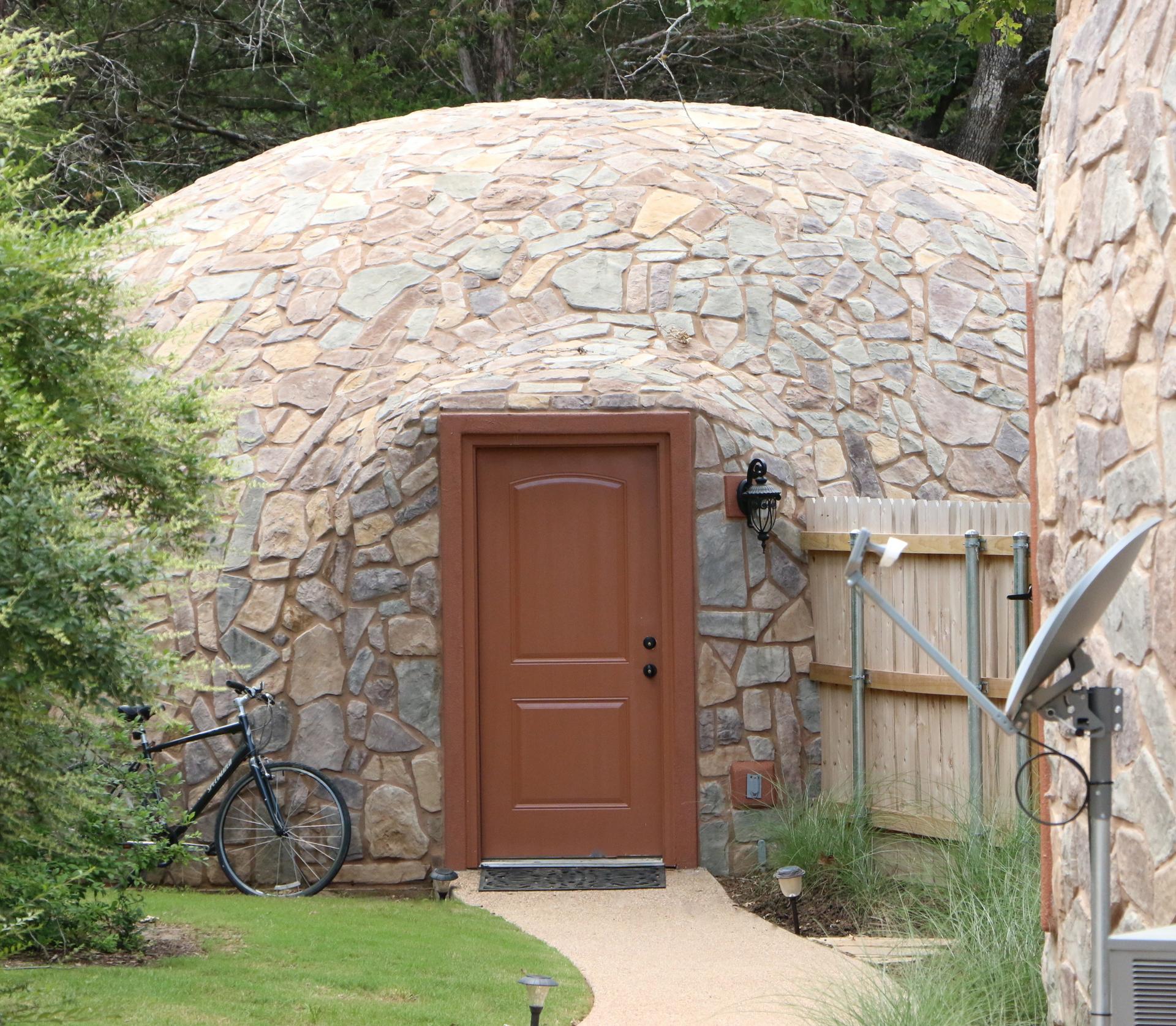 Back of stone covered dome garage.