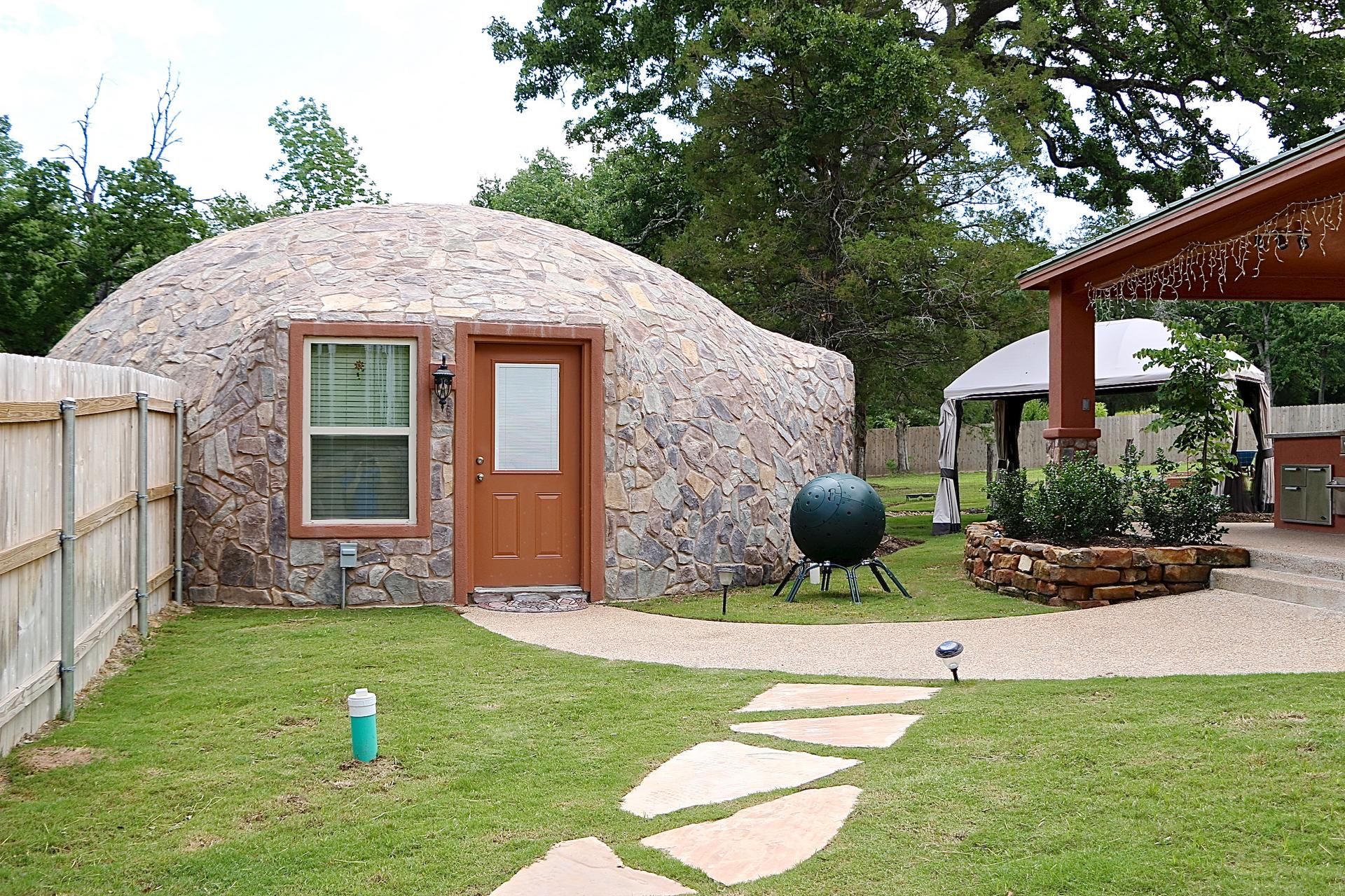 Stone walk leads to Monolithic Dome guest house.