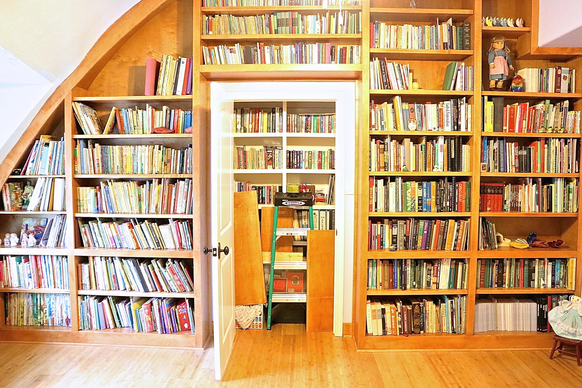 Door built into shelves leads to next room.
