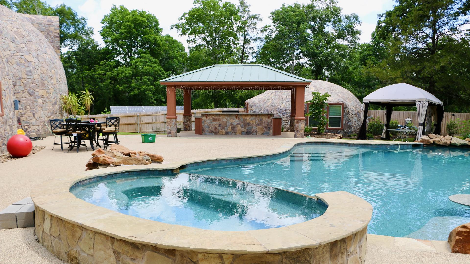 S-shaped swimming pool and dome guest house.