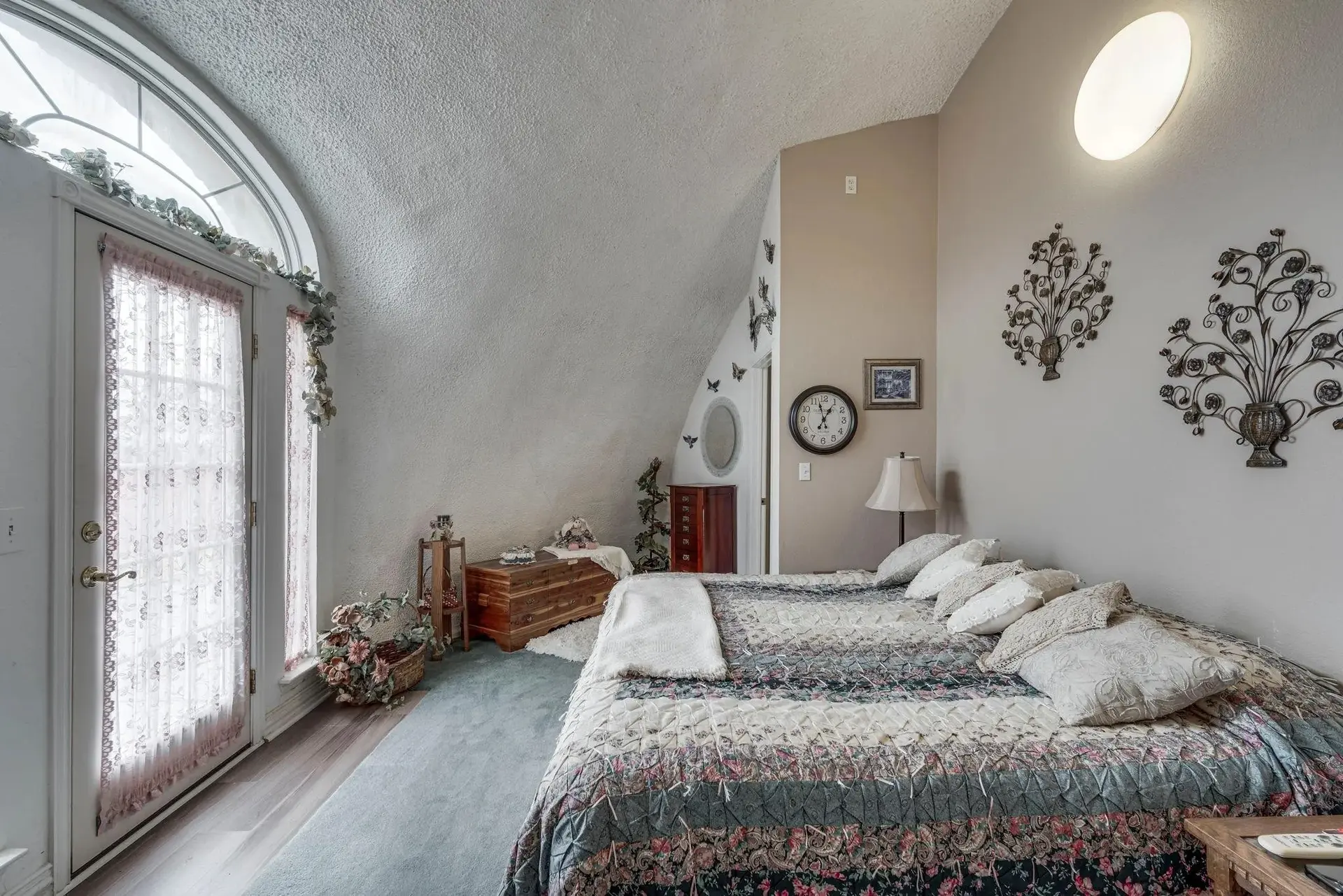 The main bedroom with arched exit to the back patio.