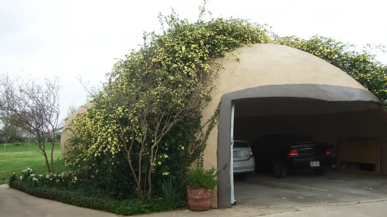 Blooming yellow roses cover EcoShell garage in Texas Blooming yellow roses cover EcoShell garage in Texas.