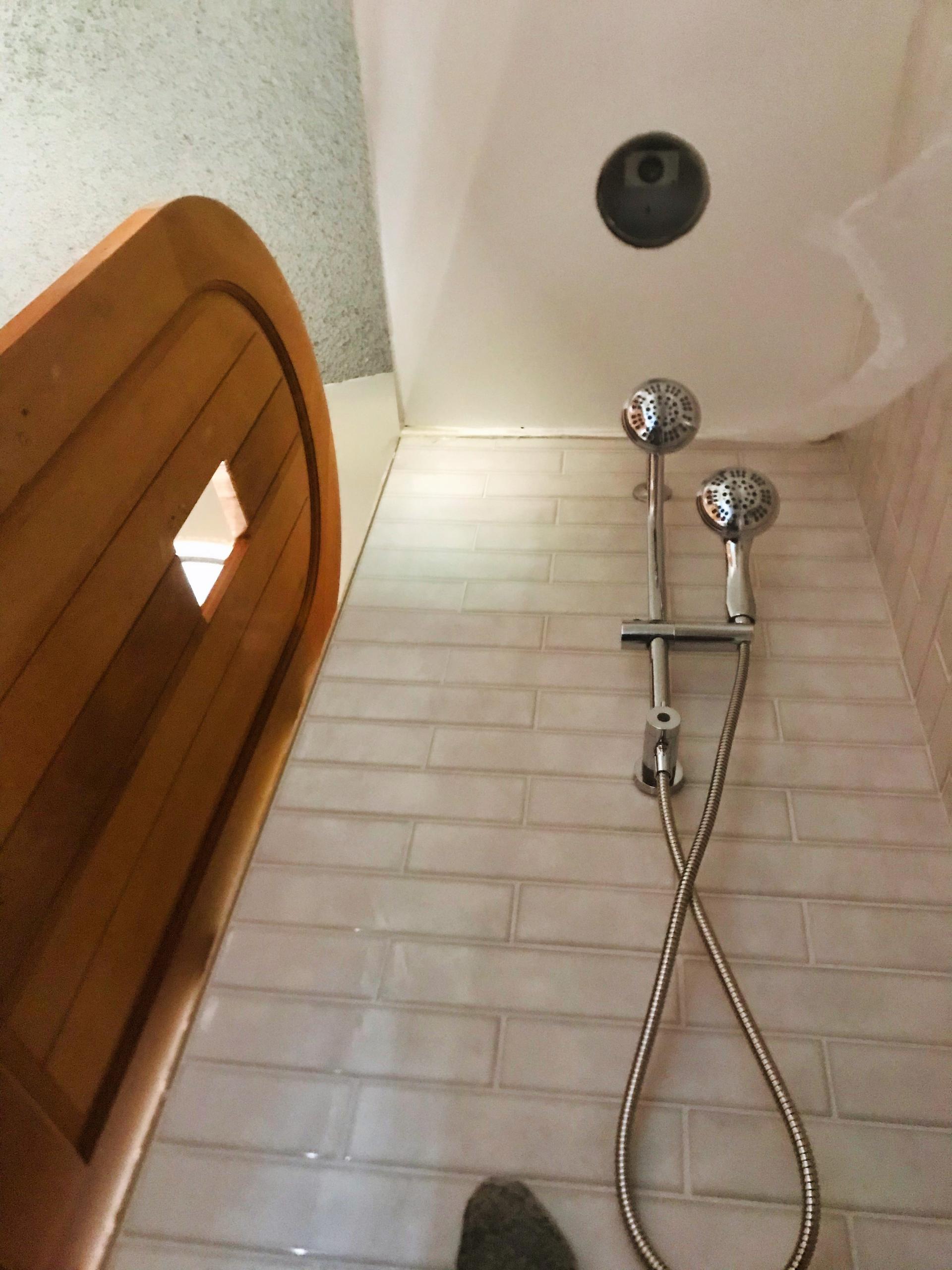 A Small Shower Tucked into an Alcove.