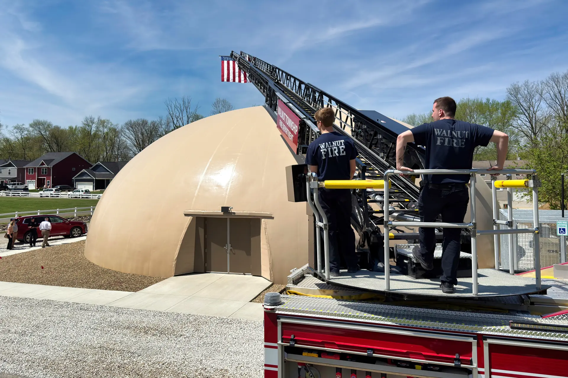 Ladder Truck Flies Flag over Tornado Shelter.